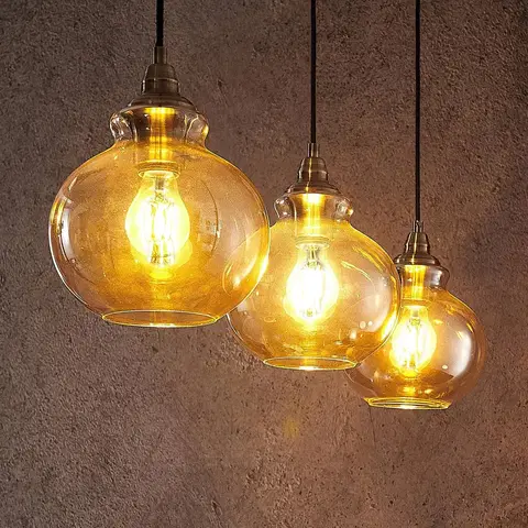 Závesné svietidlá Lindby Lindby Tymoni sklenená závesná lampa jantár 3-pl.
